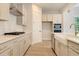 Modern kitchen with white cabinets and gold accents at 2841 Auldreeke Rd, Johns Island, SC 29455