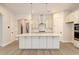 Modern kitchen featuring a large island, white cabinets, and gold accents at 2841 Auldreeke Rd, Johns Island, SC 29455