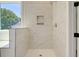 Walk-in shower with marble tile and built-in shelves at 2841 Auldreeke Rd, Johns Island, SC 29455