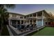Spacious backyard with pool, putting green, and lounge chairs at dusk at 3 43Rd Ave, Isle of Palms, SC 29451