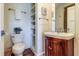 Small bathroom with a pedestal sink, open shelving, and hardwood floor at 3 43Rd Ave, Isle of Palms, SC 29451