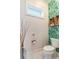 Small bathroom with tropical wallpaper and toilet at 3 43Rd Ave, Isle of Palms, SC 29451