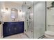 Modern bathroom with navy blue vanity and glass shower at 3 43Rd Ave, Isle of Palms, SC 29451