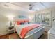 Bright bedroom with a queen-size bed and coral-colored bedding at 3 43Rd Ave, Isle of Palms, SC 29451