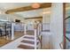 Bright and spacious entryway with wooden staircase and exposed beams at 3 43Rd Ave, Isle of Palms, SC 29451