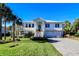 Two-story home with white siding, metal roof, and a brick driveway at 3 43Rd Ave, Isle of Palms, SC 29451