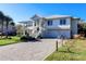 Two-story home with white siding, metal roof, and a brick driveway at 3 43Rd Ave, Isle of Palms, SC 29451