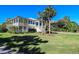 Two-story home with white siding, large porch, and lush landscaping at 3 43Rd Ave, Isle of Palms, SC 29451