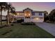 Front view of a charming two-story home with a paved driveway at 3 43Rd Ave, Isle of Palms, SC 29451