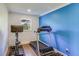 Home gym with treadmill, stationary bike, and blue accent wall at 3 43Rd Ave, Isle of Palms, SC 29451