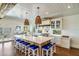 Large kitchen island with white cabinets and blue barstools at 3 43Rd Ave, Isle of Palms, SC 29451