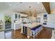Large kitchen featuring an island with seating, white cabinets, and hardwood floors at 3 43Rd Ave, Isle of Palms, SC 29451