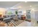 Cozy living room with a gray sectional sofa and access to outdoor patio at 3 43Rd Ave, Isle of Palms, SC 29451