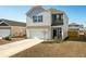 Two-story house with gray and beige siding, a white garage door, and landscaping at 307 Black Birch Dr, Summerville, SC 29486