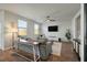 Bright living room features hardwood floors, comfy seating, and a large TV at 307 Black Birch Dr, Summerville, SC 29486