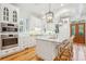 Bright kitchen features white cabinets, marble island, and stainless steel appliances at 31 Frogmore Rd, Mount Pleasant, SC 29464