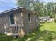 Brick home corner showing small windows and grassy yard at 310 Adeline Dr, Goose Creek, SC 29445
