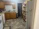 Modest kitchen featuring wood cabinetry, neutral countertops, and tiled flooring at 310 Adeline Dr, Goose Creek, SC 29445
