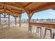 Wooden covered deck with bar stools and picnic table overlooking the water at 320 Longshore Street St # 1044, Charleston, SC 29492