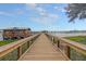 Wooden walkway to a waterfront structure with scenic views at 320 Longshore Street St # 1044, Charleston, SC 29492