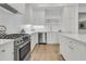 Modern kitchen with white cabinets, quartz countertops, and stainless steel appliances at 320 Longshore Street St # 1044, Charleston, SC 29492