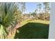 Spacious backyard with lush grass, offering a tranquil view of the water at 3578 Clambank Dr, Mount Pleasant, SC 29466