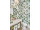 Small powder room with a marble sink and palm-tree wallpaper at 3578 Clambank Dr, Mount Pleasant, SC 29466