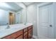 Double vanity bathroom with wood cabinets and a large mirror at 4240 William E Murray Blvd, Charleston, SC 29414