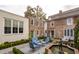 Landscaped courtyard with seating area and a fountain at 43 Hasell St, Charleston, SC 29401
