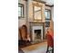 Elegant dining room features a marble fireplace, ornate mirror, and patterned wallpaper at 43 Hasell St, Charleston, SC 29401