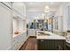Spacious kitchen boasts marble countertops, custom cabinetry, and high-end appliances at 43 Hasell St, Charleston, SC 29401