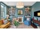 Spacious living room featuring built-in bookshelves and a fireplace at 43 Hasell St, Charleston, SC 29401