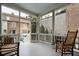Relaxing screened porch with rocking chairs and view of courtyard at 43 Hasell St, Charleston, SC 29401