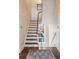 Elegant staircase with ornate banister and patterned wallpaper at 43 Hasell St, Charleston, SC 29401