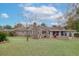Brick house with grassy backyard, patio, and fire pit at 4334 Bream Rd, North Charleston, SC 29418