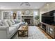 Open living space with a fireplace, sectional sofa, and hardwood floors at 4334 Bream Rd, North Charleston, SC 29418