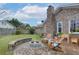 Cozy patio with fire pit, brick wall, and wood adirondack chairs at 4334 Bream Rd, North Charleston, SC 29418