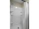 Updated shower with built-in shelving and white shower curtain at 4334 Bream Rd, North Charleston, SC 29418