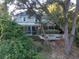 House surrounded by lush trees, screened porch and garden at 469 Fort Johnson Rd, Charleston, SC 29412