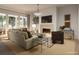 Bright living room features a fireplace, comfy seating, and large windows at 515 Helmsman St # 515, Daniel Island, SC 29492