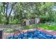 Large backyard with playset, shed, and garden boxes at 5242 Potomac St, North Charleston, SC 29405
