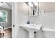 Small bathroom with pedestal sink and beadboard wainscoting at 5242 Potomac St, North Charleston, SC 29405