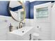 Modern bathroom with white vanity, gold accents, and blue walls at 5242 Potomac St, North Charleston, SC 29405