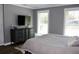 Bright bedroom with wood floors, two windows, and gray walls at 5242 Potomac St, North Charleston, SC 29405