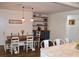 Open dining room with farmhouse decor, pendant lights and a blue built-in at 5242 Potomac St, North Charleston, SC 29405