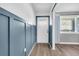 Bright entryway with white door and blue wainscoting at 5242 Potomac St, North Charleston, SC 29405