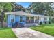 Cute one-story home with blue and white exterior, covered porch, and well-manicured lawn at 5242 Potomac St, North Charleston, SC 29405
