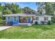 Charming one-story home with blue and white exterior, covered porch, and well-manicured lawn at 5242 Potomac St, North Charleston, SC 29405