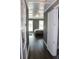 Hallway view leading into a gray bedroom with hardwood floors and abundant natural light at 5242 Potomac St, North Charleston, SC 29405