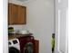 Efficient laundry room with a red washer, white dryer and wooden shelf at 5242 Potomac St, North Charleston, SC 29405